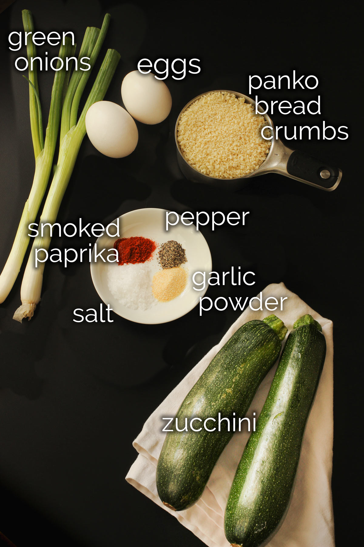 ingredients for baked zucchini fritters laid out on the tabletop.