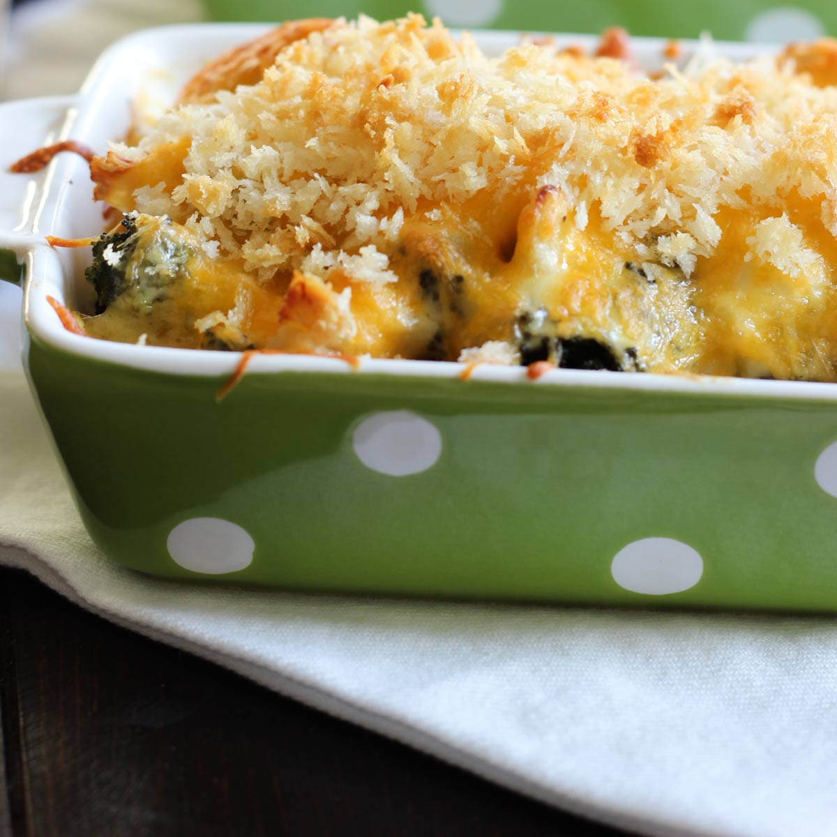 single serve green rectangle dish with chicken divan topped with breadcrumbs.