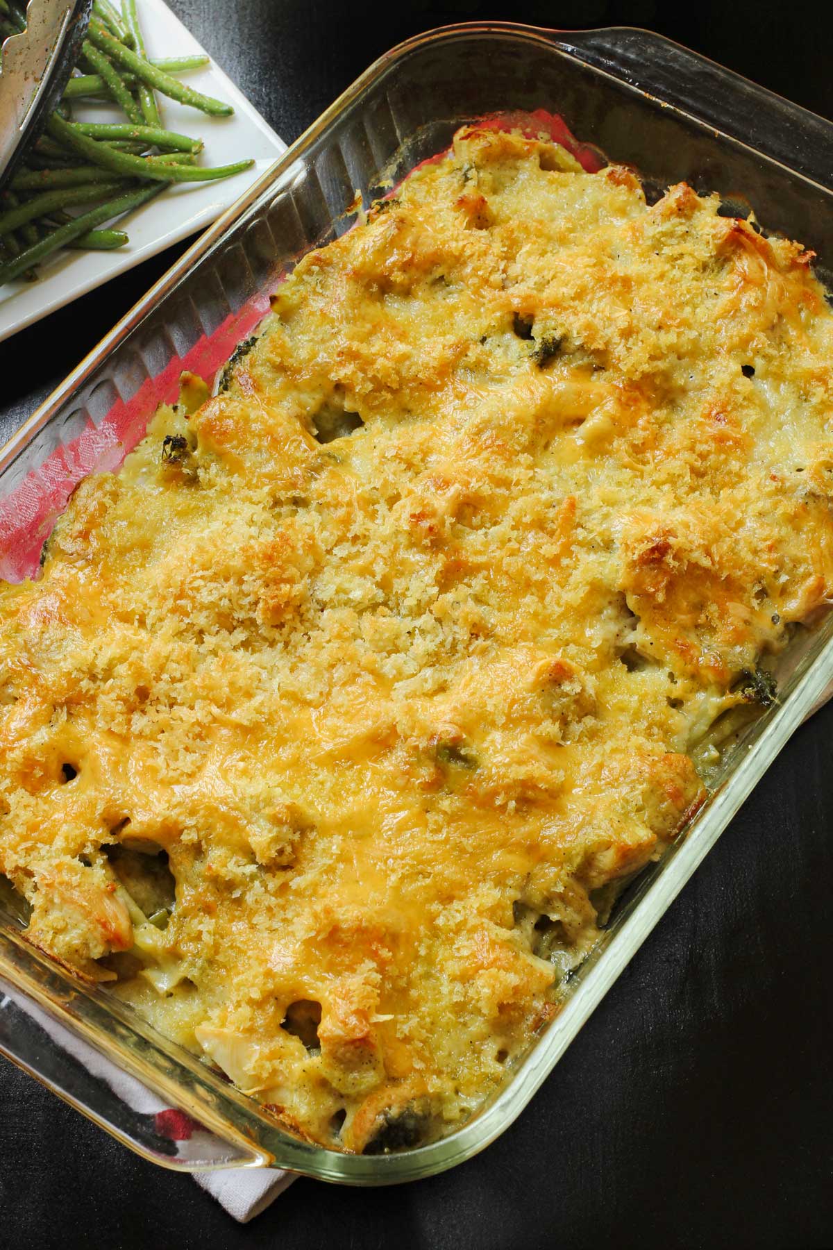 baked chicken curry divan in glass baking dish on dinner table.