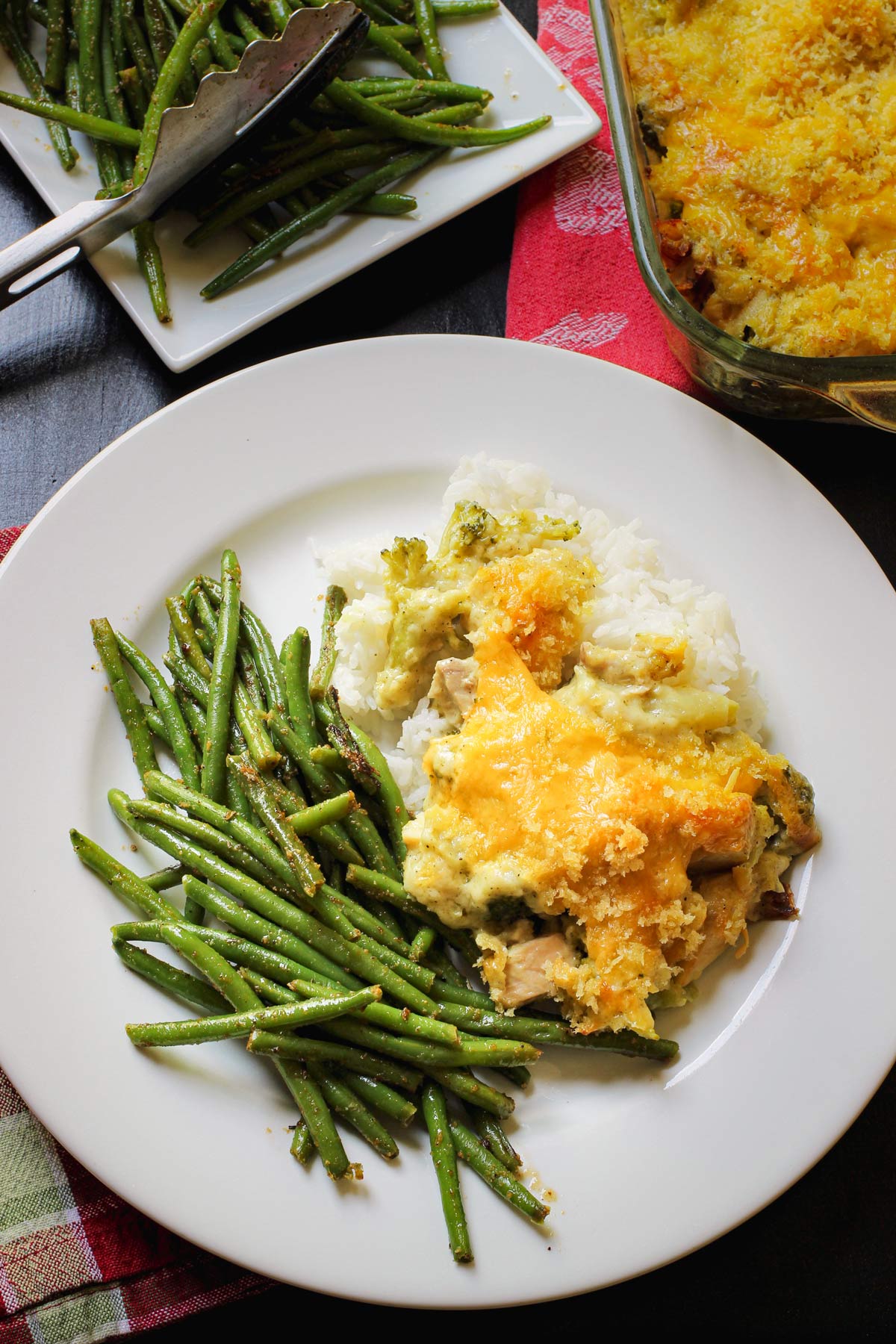 chicken divan on dinner plate with rice and green beans.