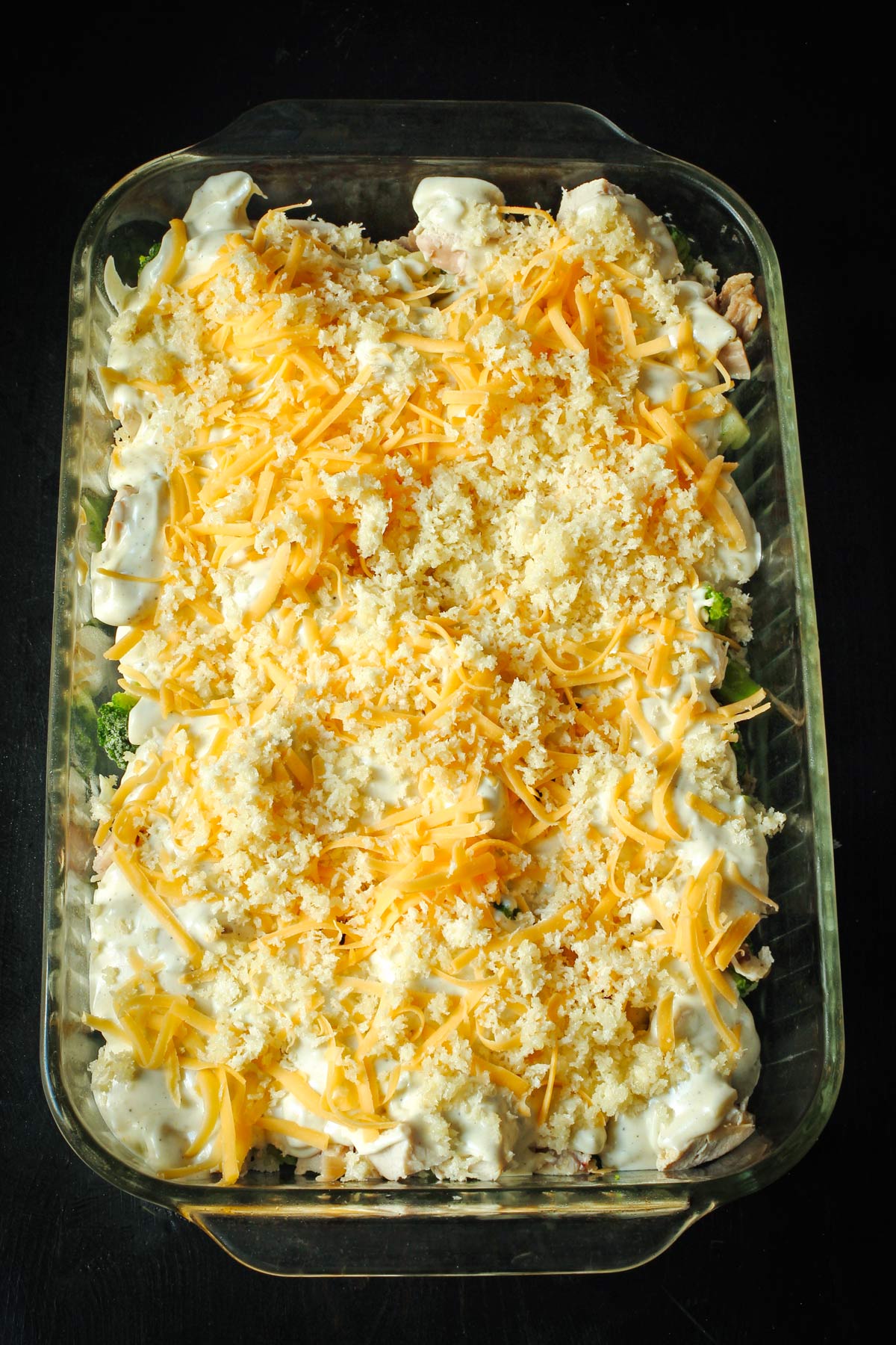 buttered breadcrumbs scattered over the cheese layer on the casserole.