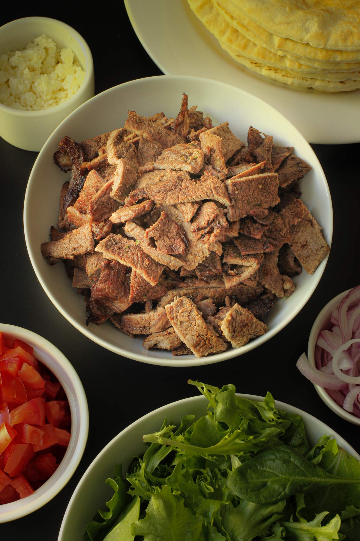 chopped grilled sirloin tip steak in a dish on dinner buffet table.