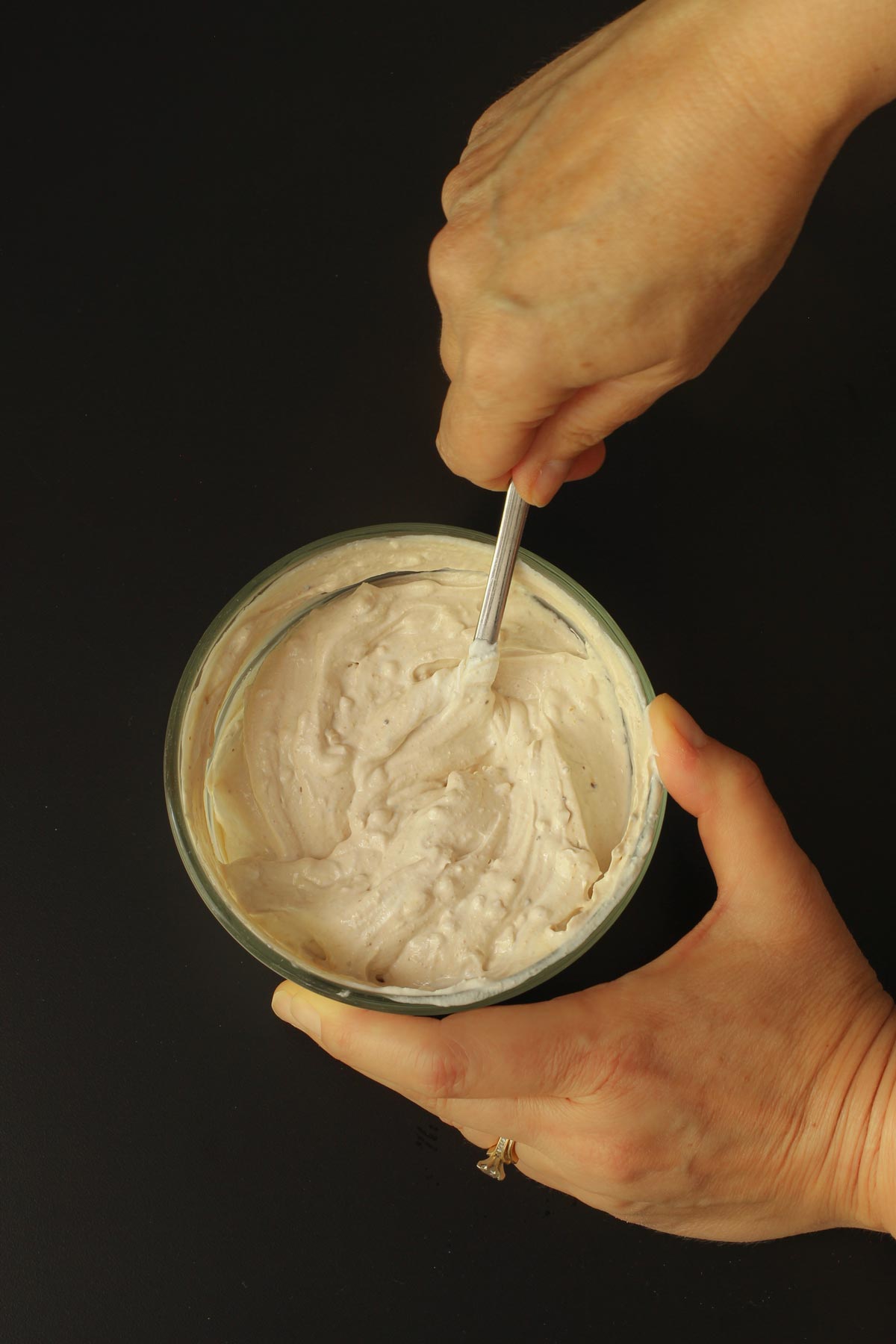 stirring the finished onion dip to serve.