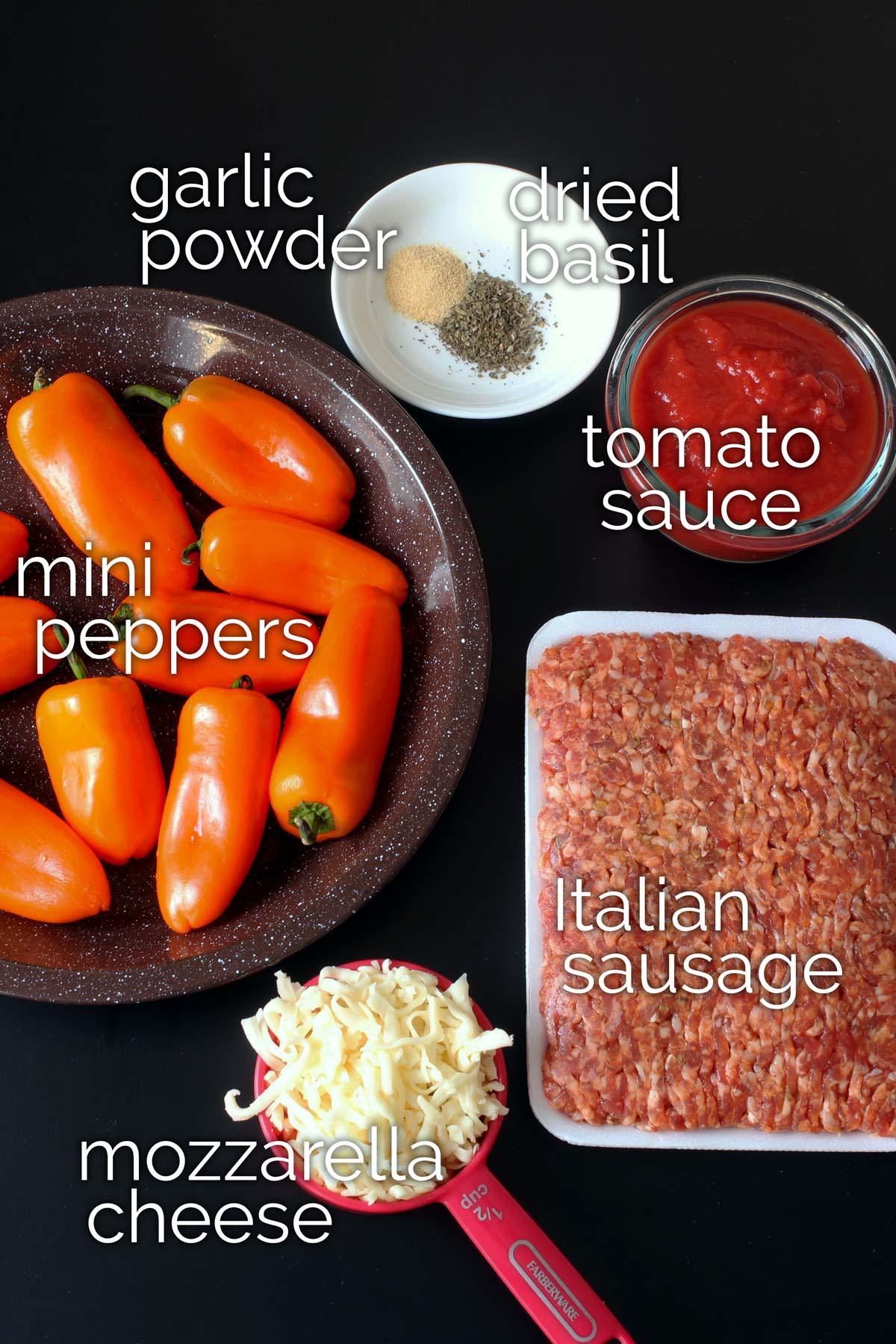 ingredients for stuffed mini peppers on black table.