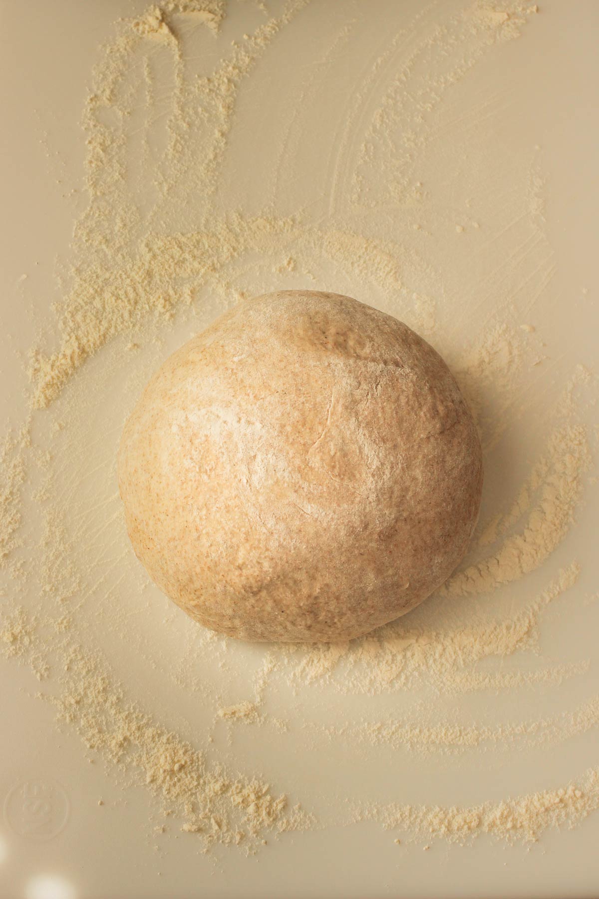 smooth boule resting on the floured work surface.