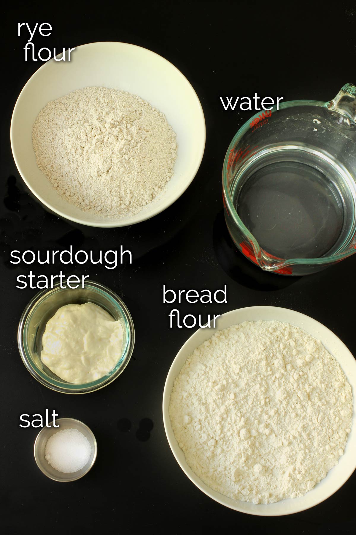 ingredients for sourdough rye bread laid out on tabletop.