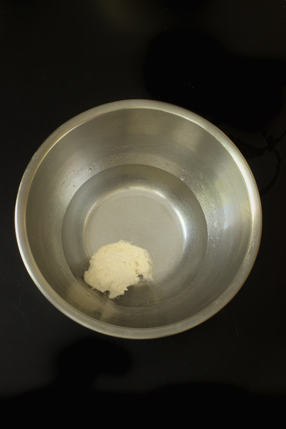 sourdough starter floating in bowl of water.