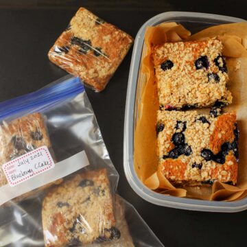 coffee cake packed in plastic container with parchment as well as individual squares wrapped in plastic.