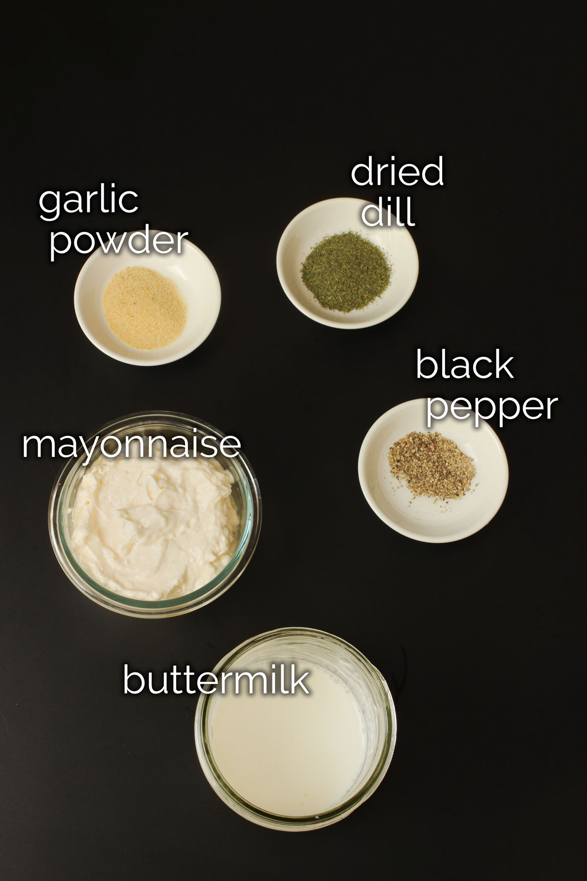 ingredients for buttermilk dressing laid out on tabletop.