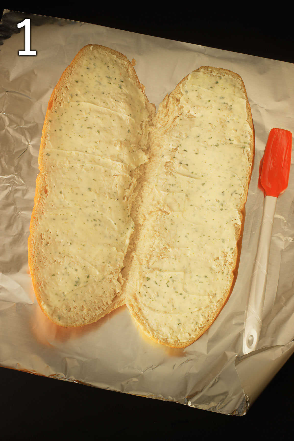 split loaf of French bread on sheet of foil, spread with garlic butter on both sides.