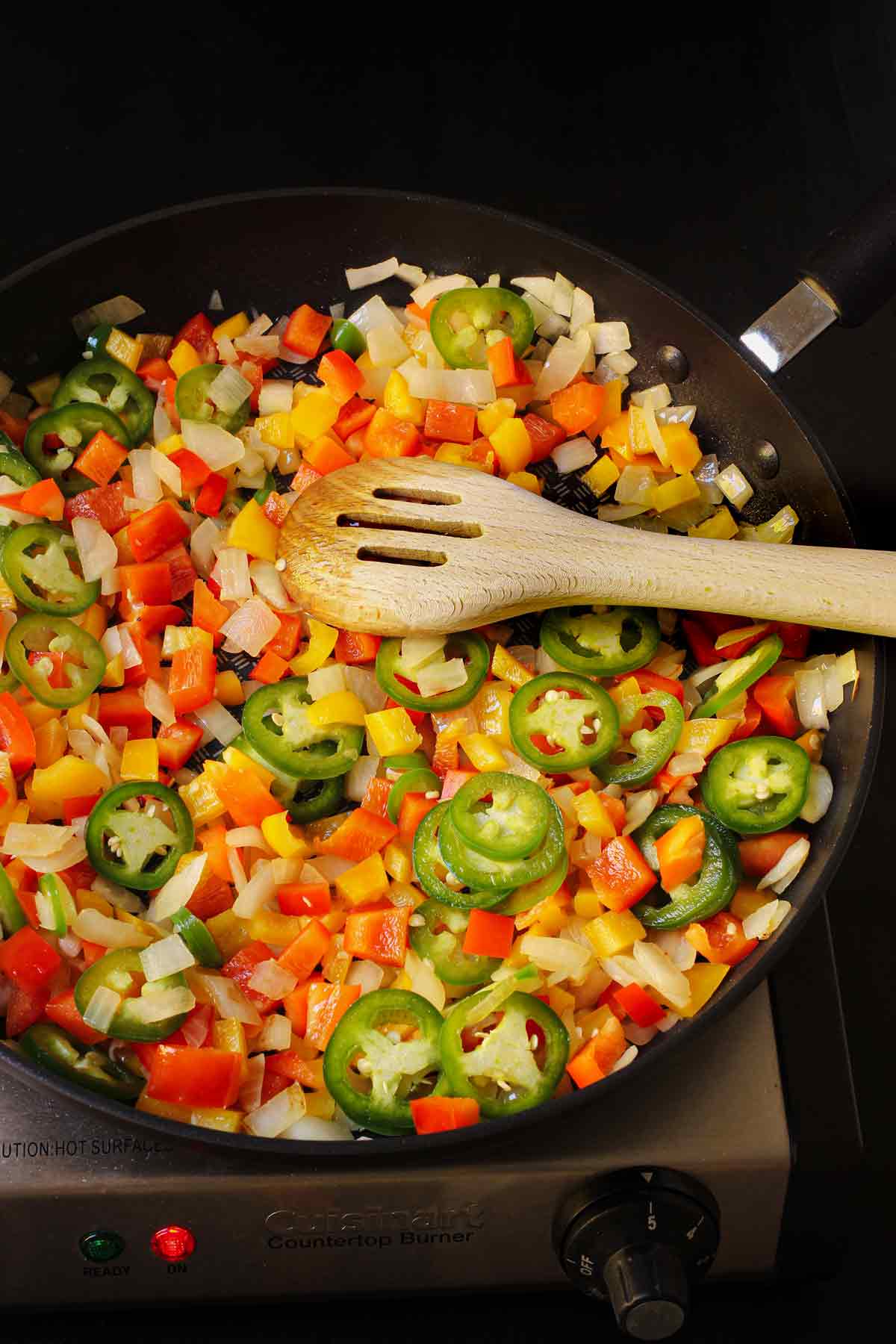 the cooked vegetables in the skillet with a wooden spoon.