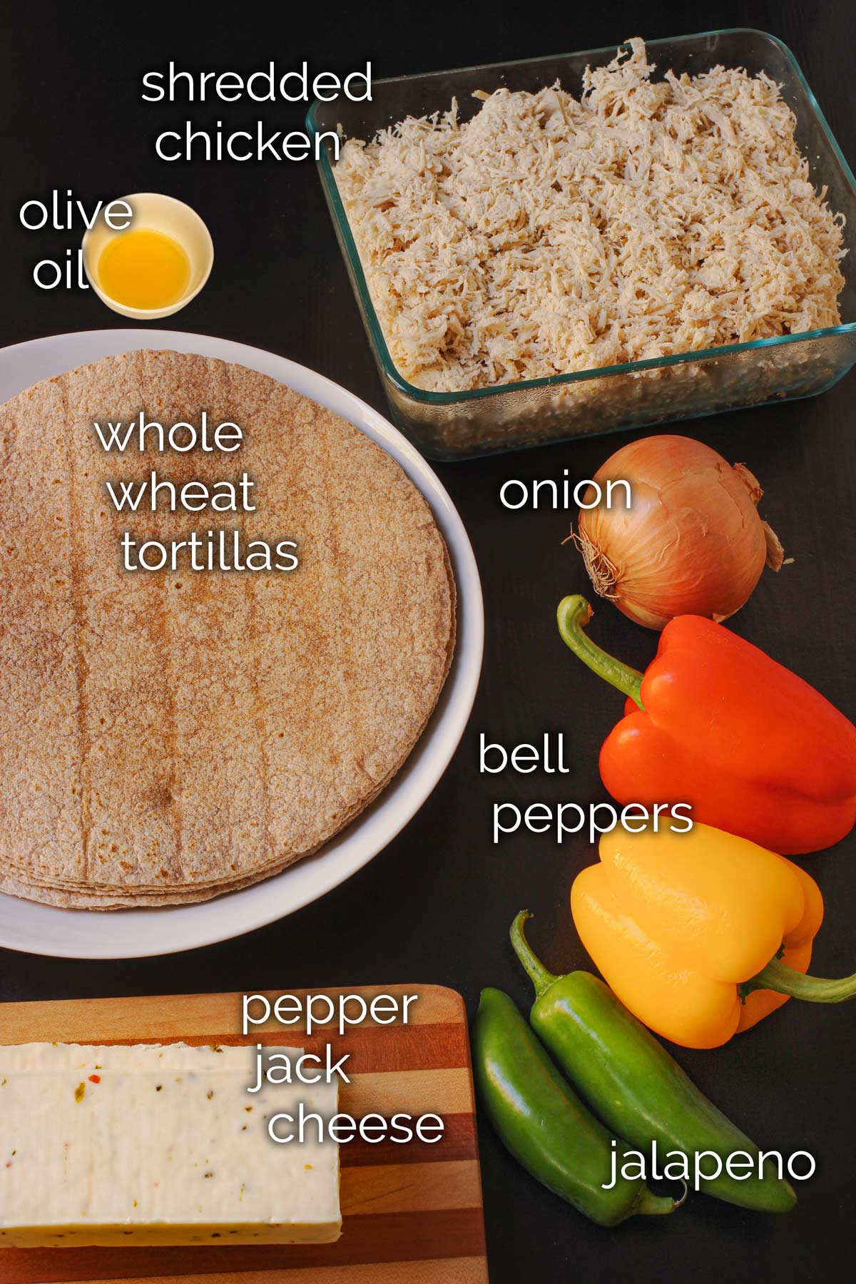 ingredients for chicken fajita burritos laid out on table top.