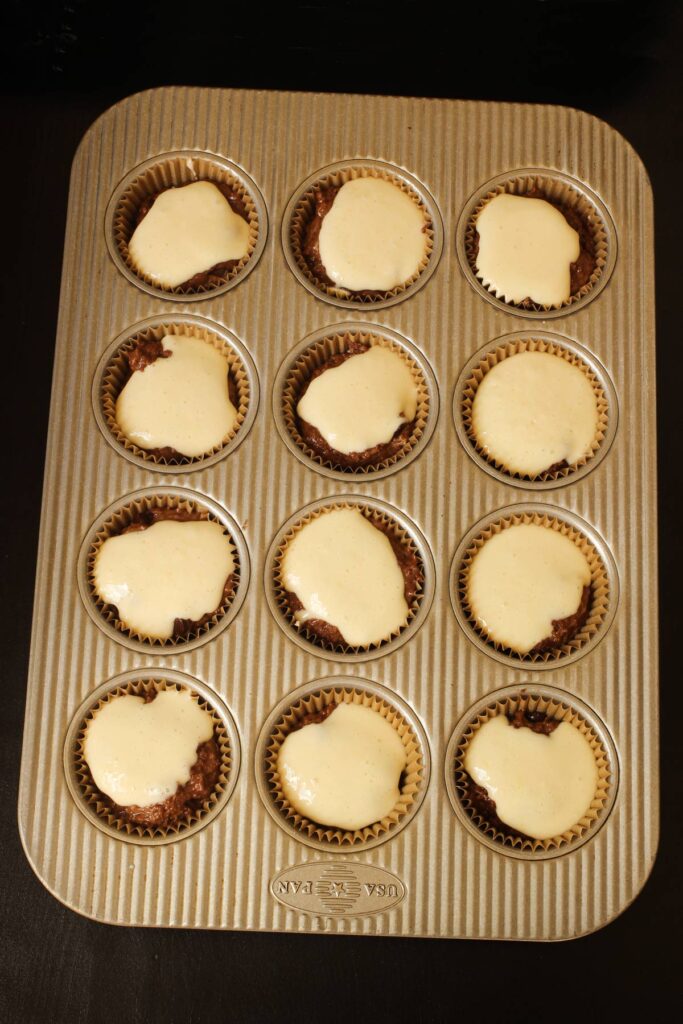 muffins topped with cream cheese mixture.