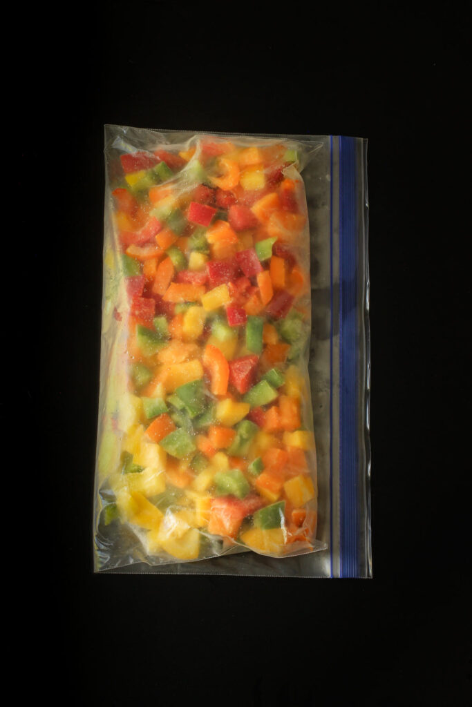 chopped colored bell peppers in a ziptop freezer bag.