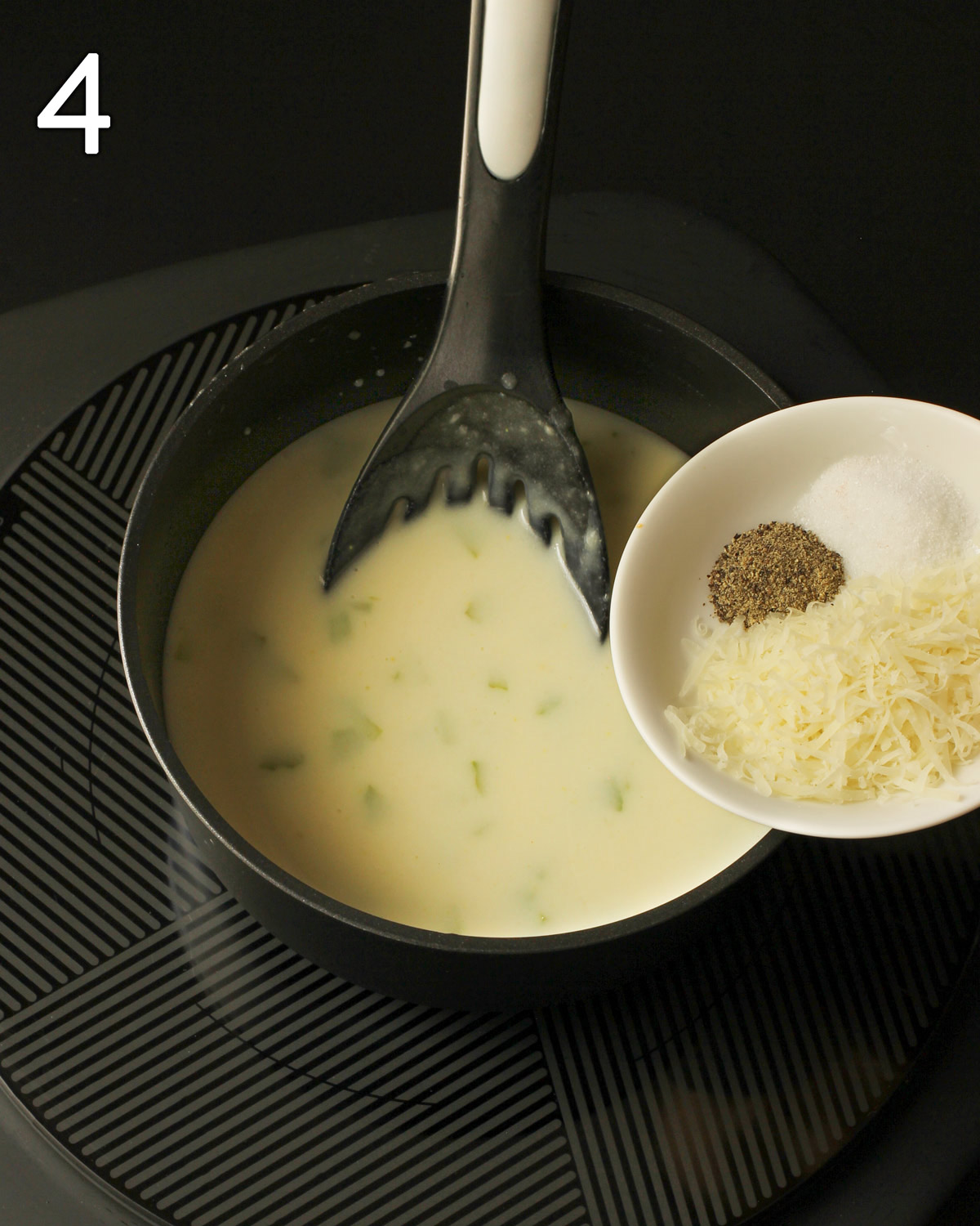 adding the seasonings to the cream of celery soup in the pan.