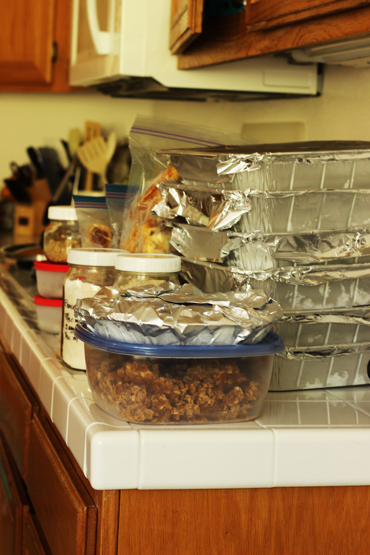 stacks of freezer meals on kitchen counter ready to be frozen.