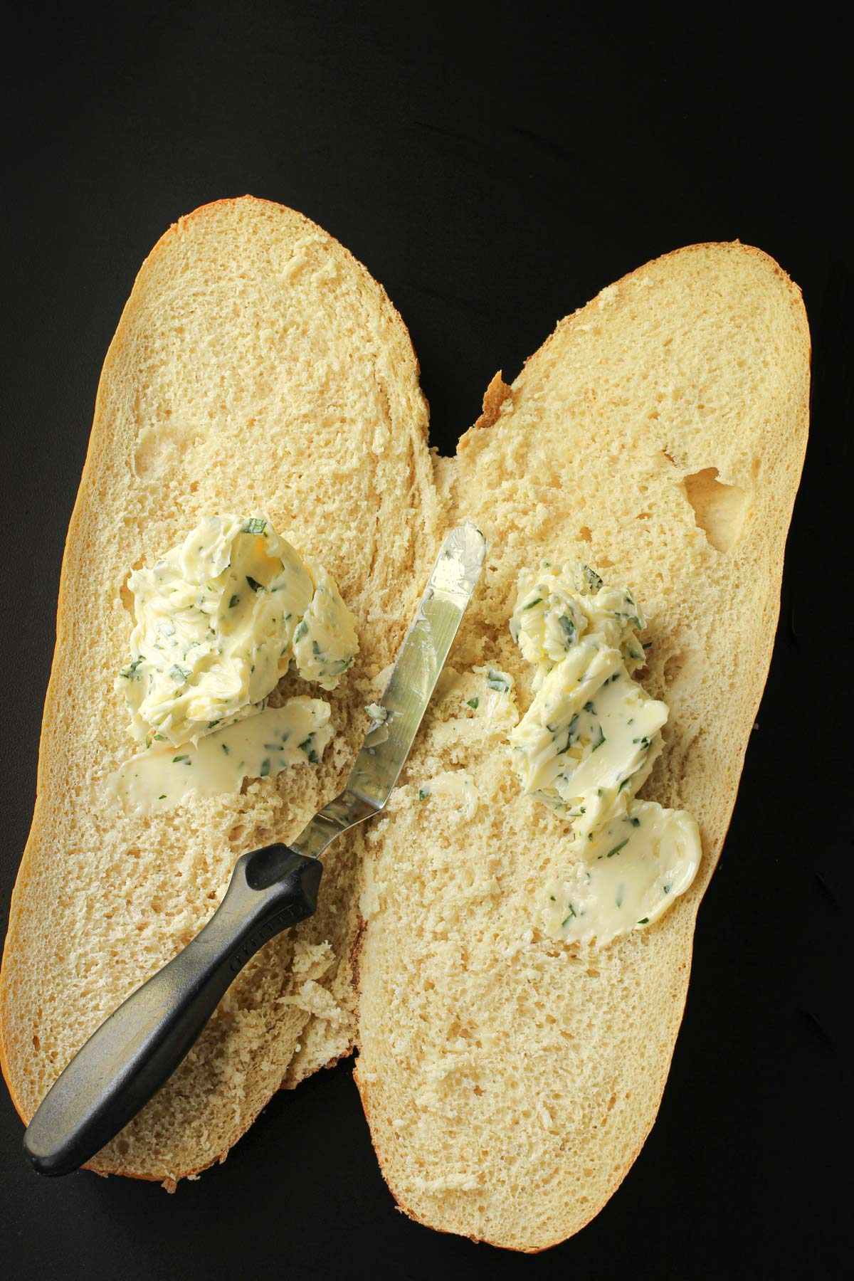 garlic butter divided between the two halves of bread.