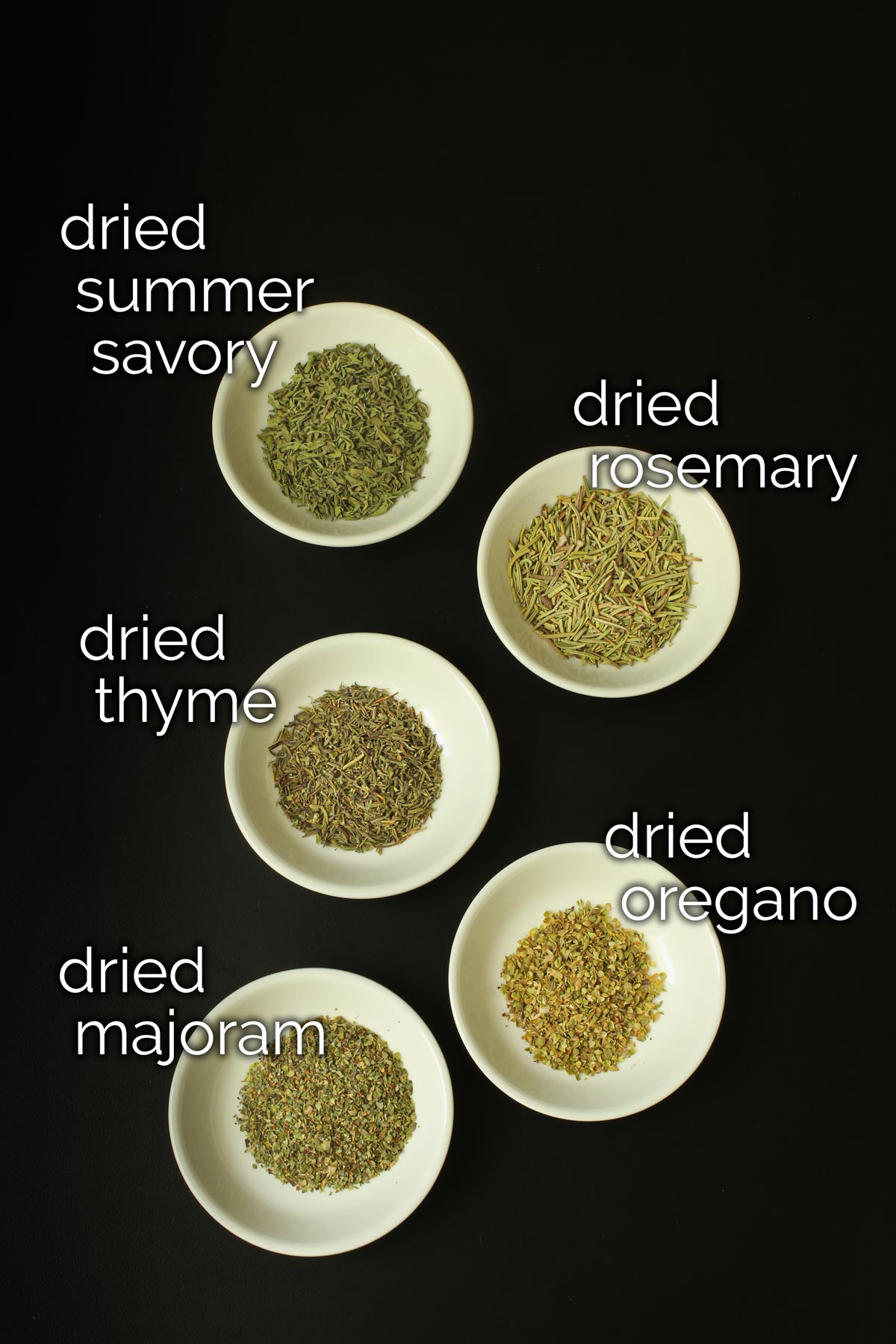 ingredients for homemade herbes de provence in small white dishes.