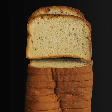 sliced sandwich bread on black table top.