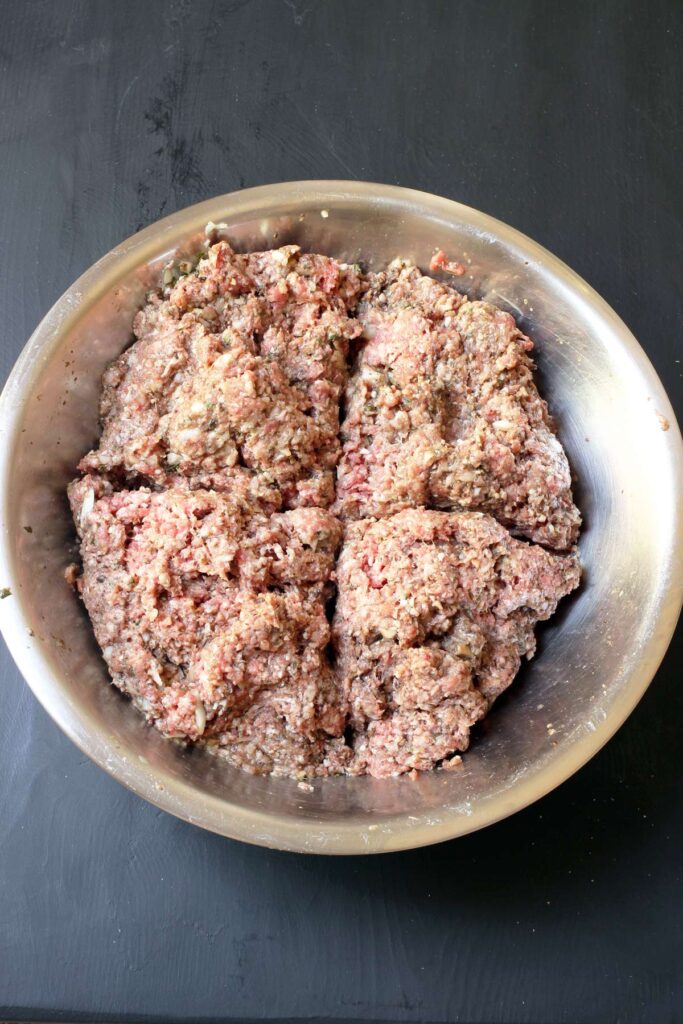 meat mixture in large mixing bowl, divided into quarters.