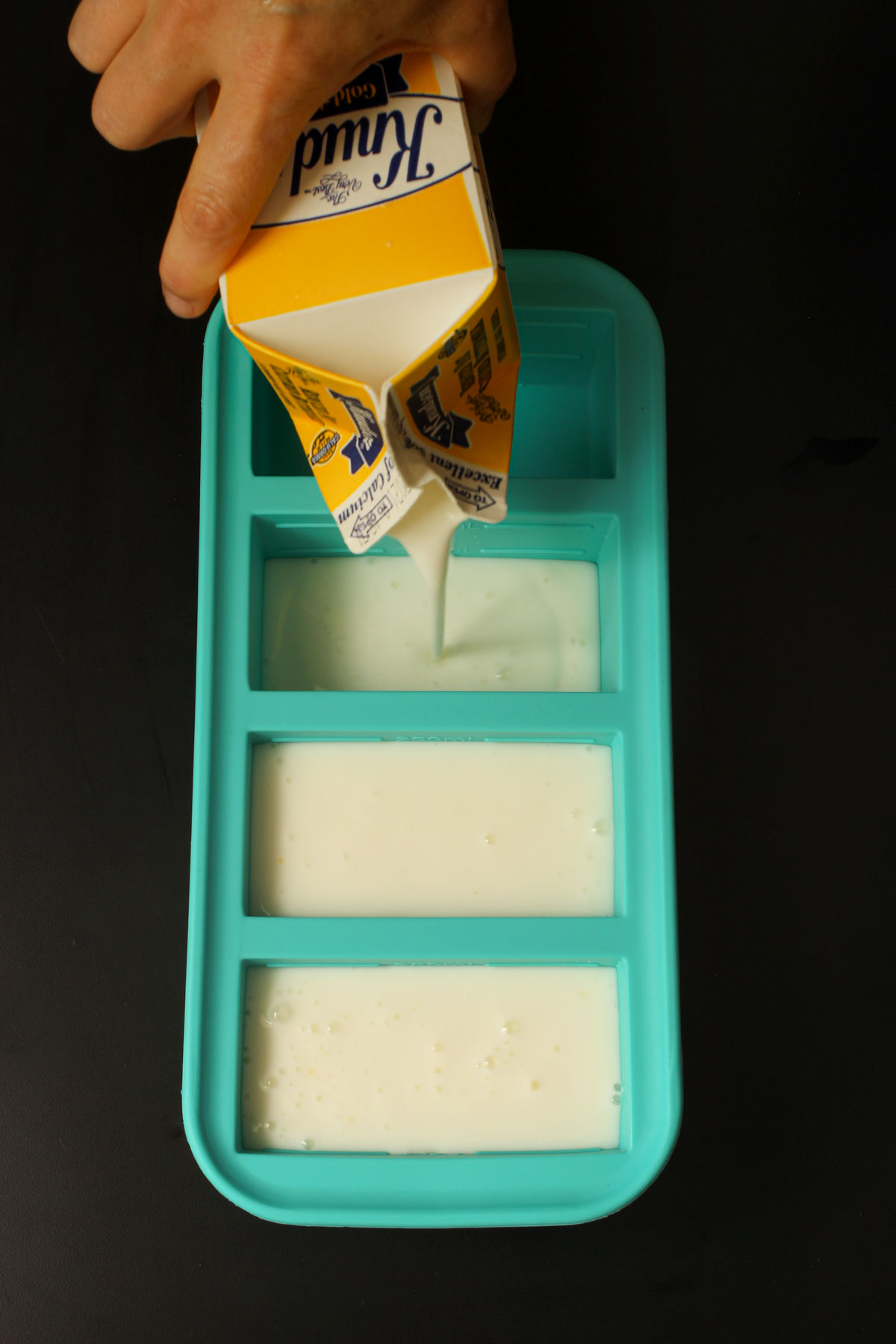 pouring buttermilk into soupercubes.