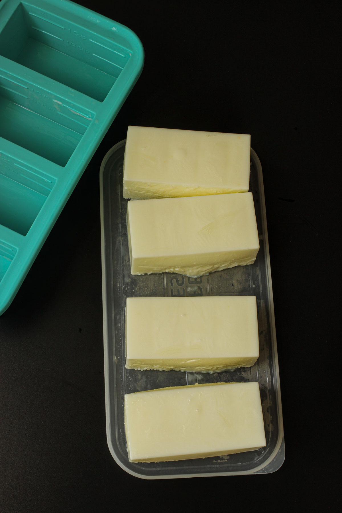 one-cup bricks of buttermilk on the soupercube lid next to the soupercube mold.