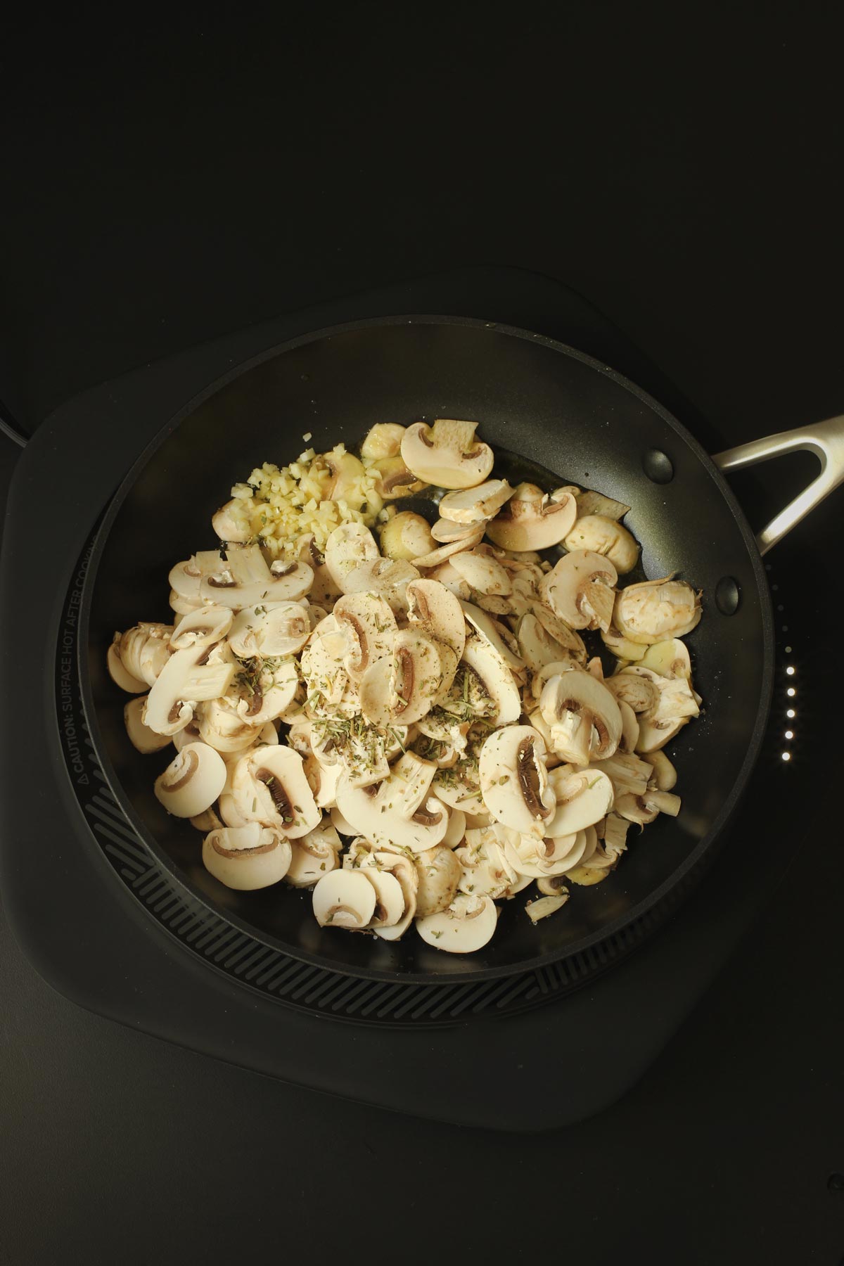 mushrooms and garlic added to the skillet.