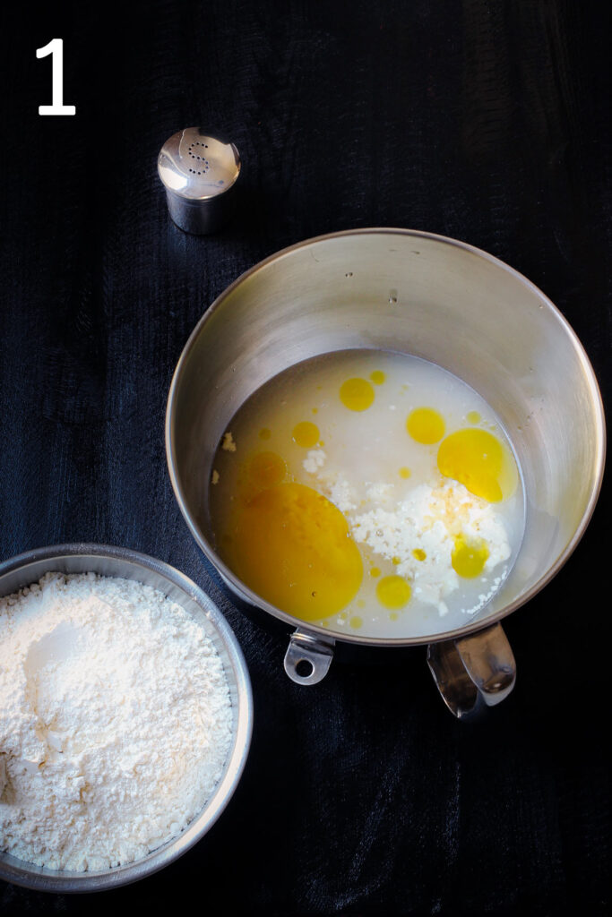 bowl of wet ingredients next to bowl of flour and salt shaker.