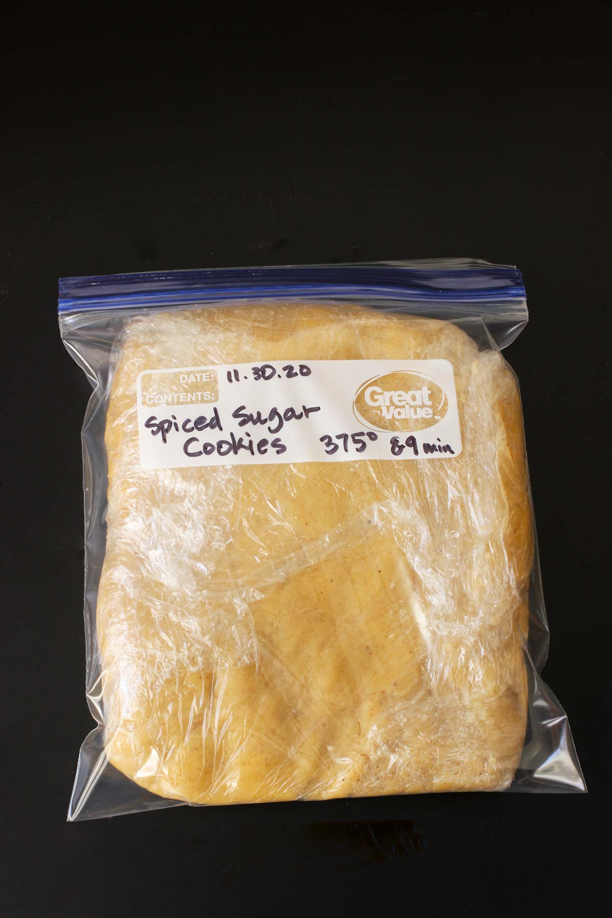 sugar cookie dough wrapped in plastic and then tucked into ziptop freezer bag.