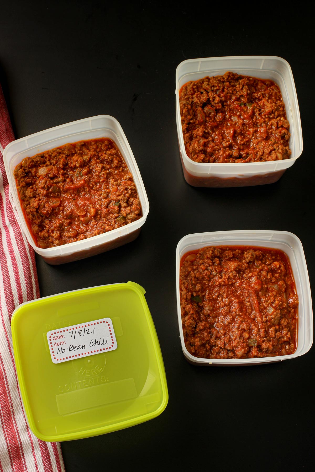 no bean chili divided into square freezer containers for lunch.
