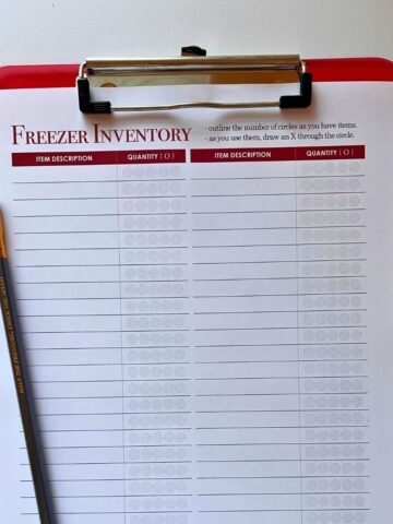 square crop of freezer inventory sheet on red clipboard.