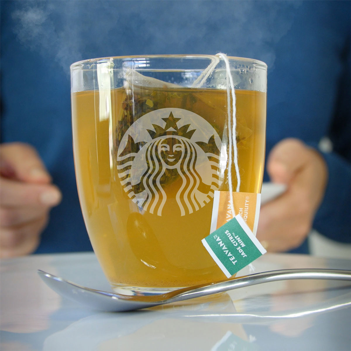 glass mug of medicine ball tea with steam rising.