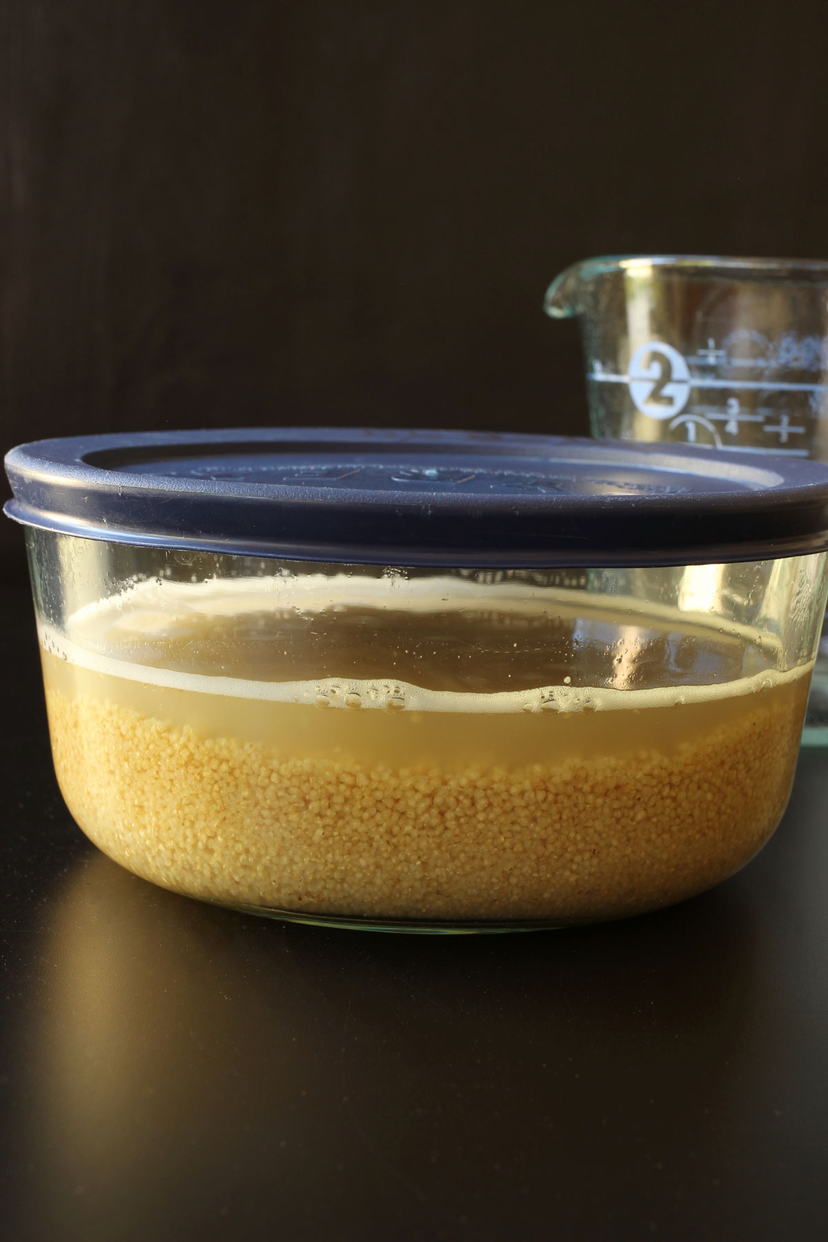 broth and couscous in glass dish with lid.