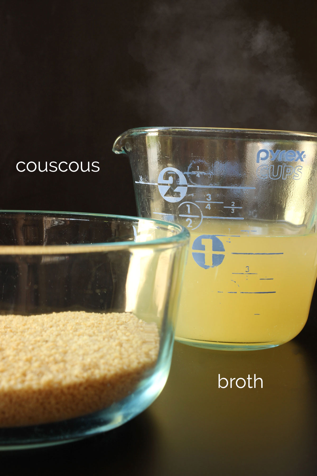 couscous in a glass dish next to hot chicken broth in a glass measuring cup.