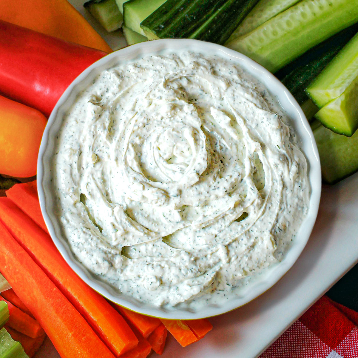dill dip in small round dish on veggie tray.