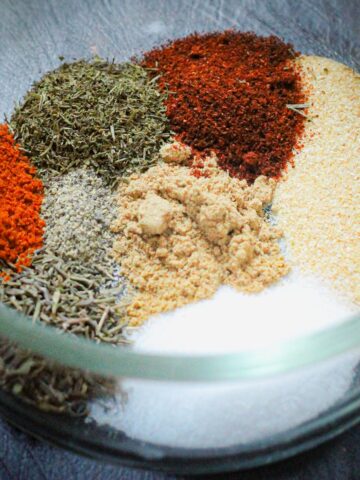 ingredients for fish seasoning in a small glass bowl.