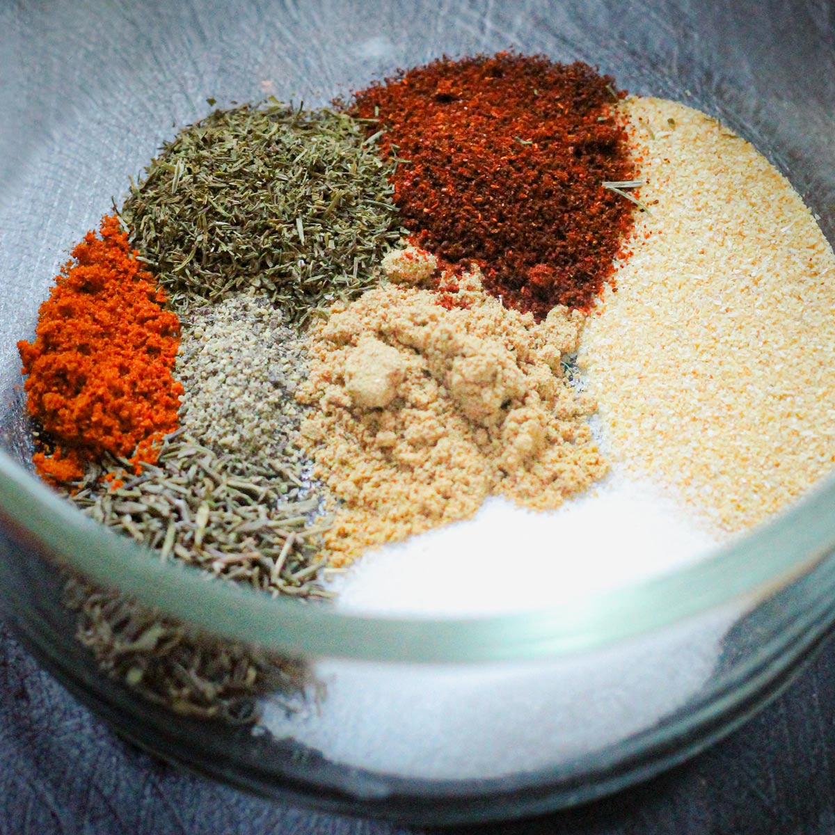 ingredients for fish seasoning in a small glass bowl.