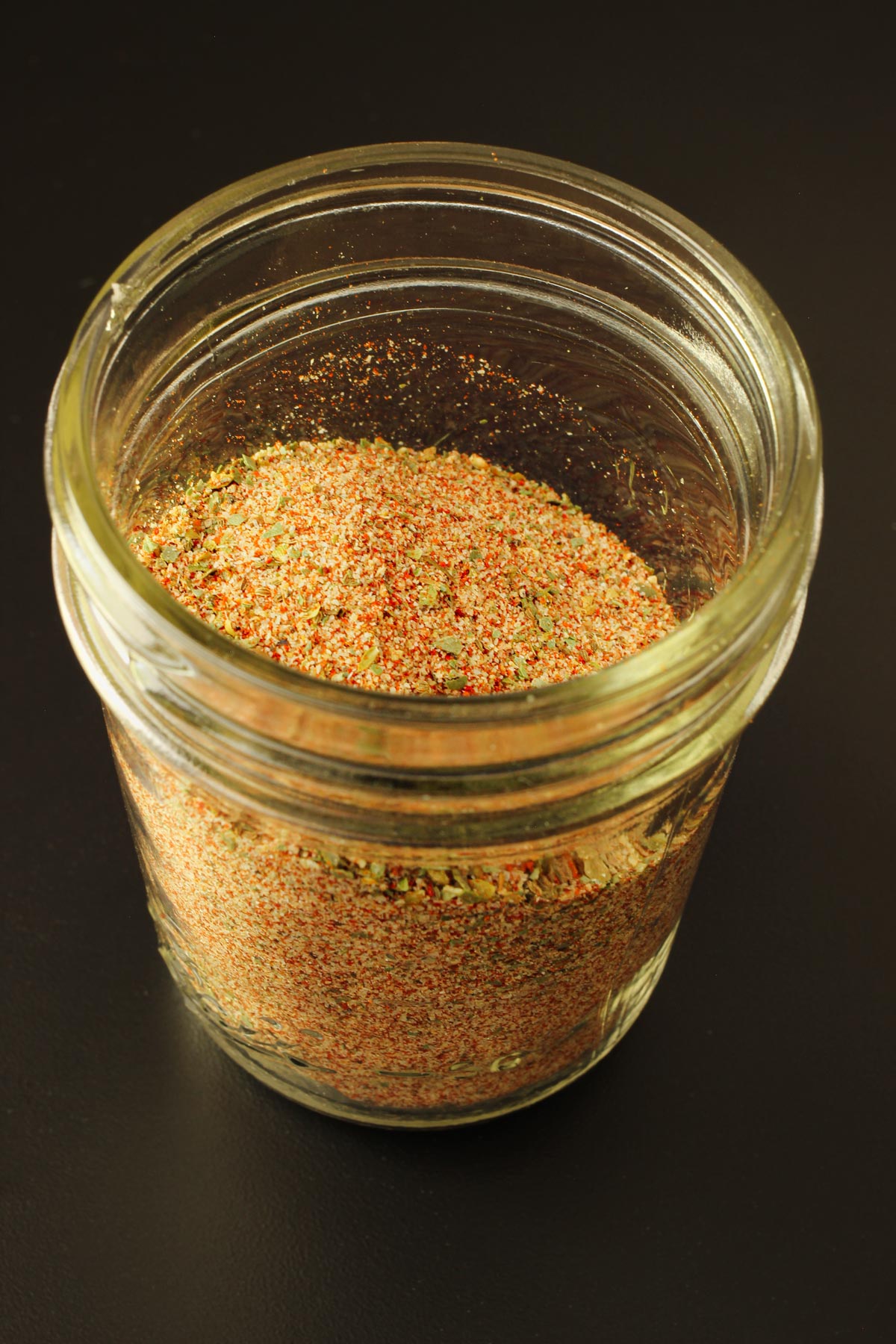 small mason jar filled with jamie's spice mix.