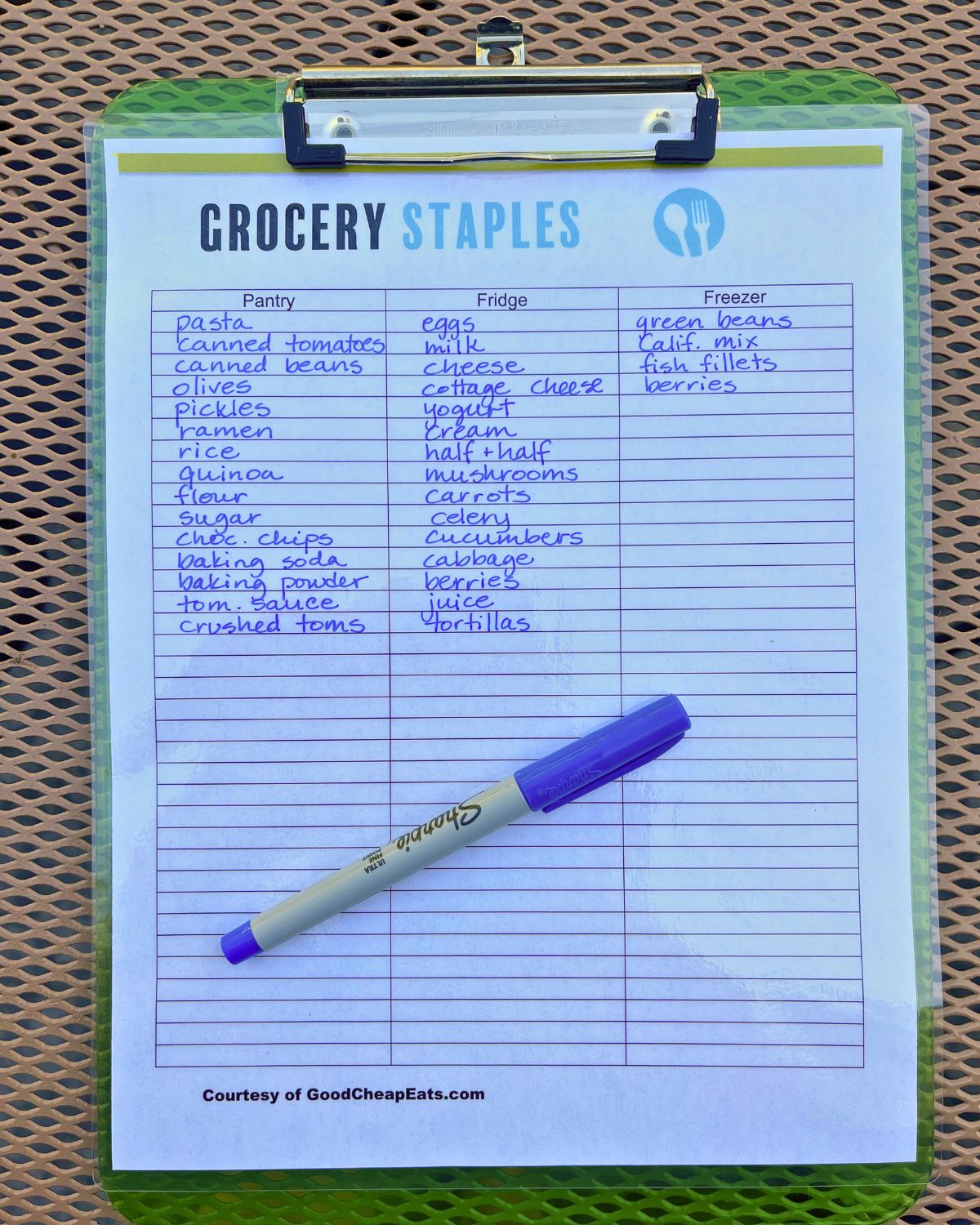 laminated paper grocery list on clipboard with sharpie.