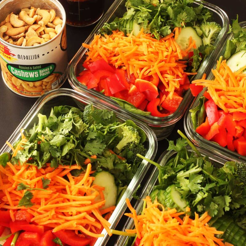 meal prep salads in glass rectangular dishes.