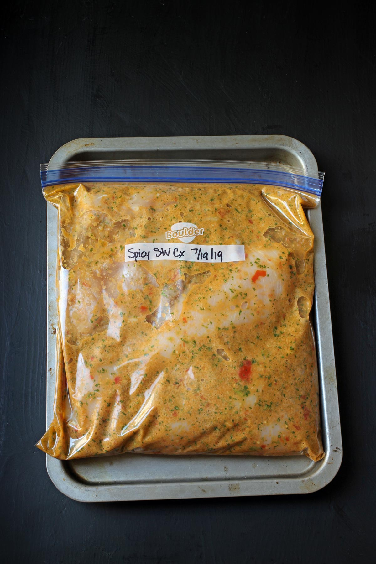 spicy chicken and marinade in ziptop freezer bag.