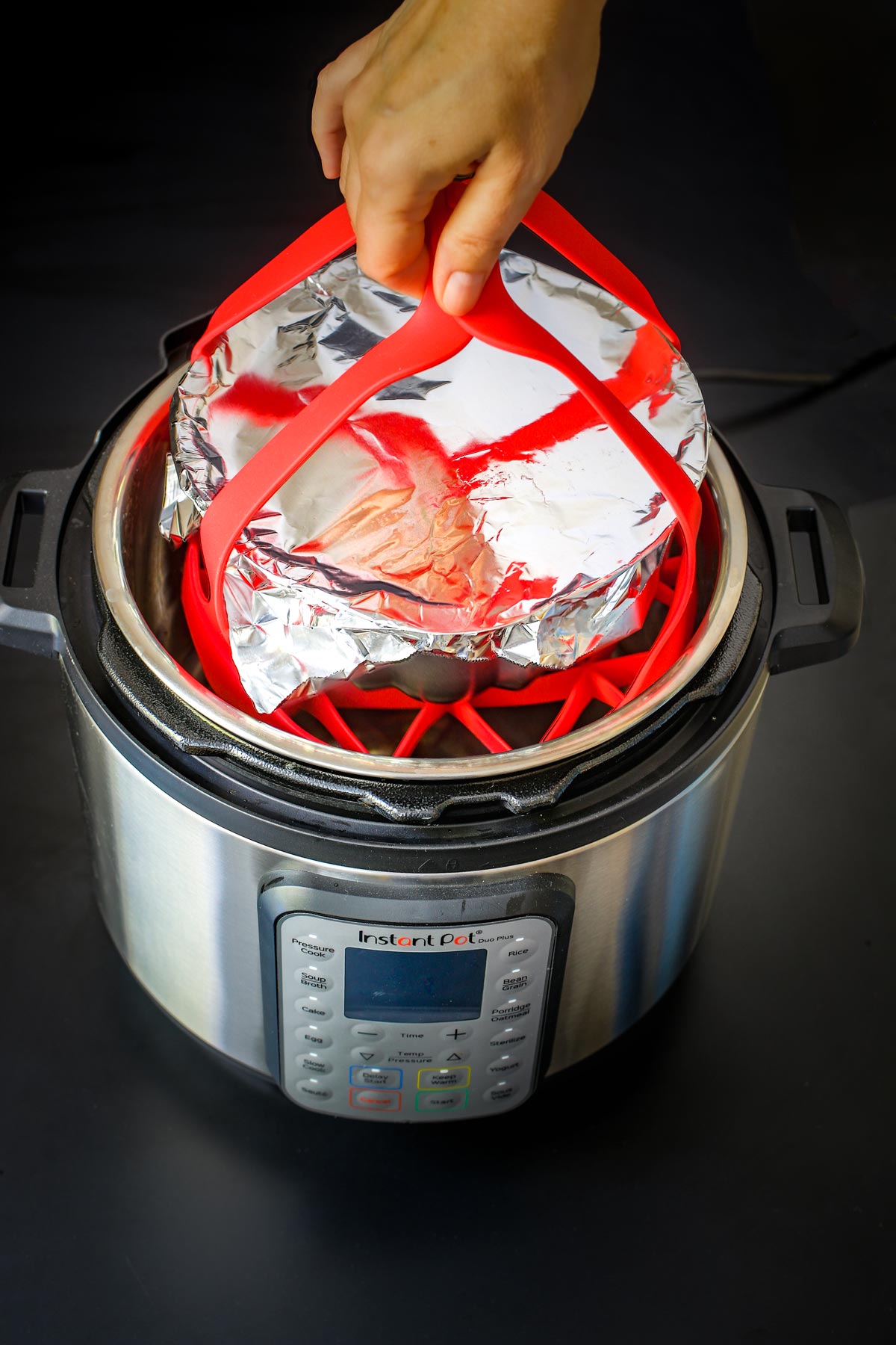 lowering pan into pressure cooker on bakeware sling.