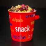 red snack bowl piled high with homemade nut-free trail mix.
