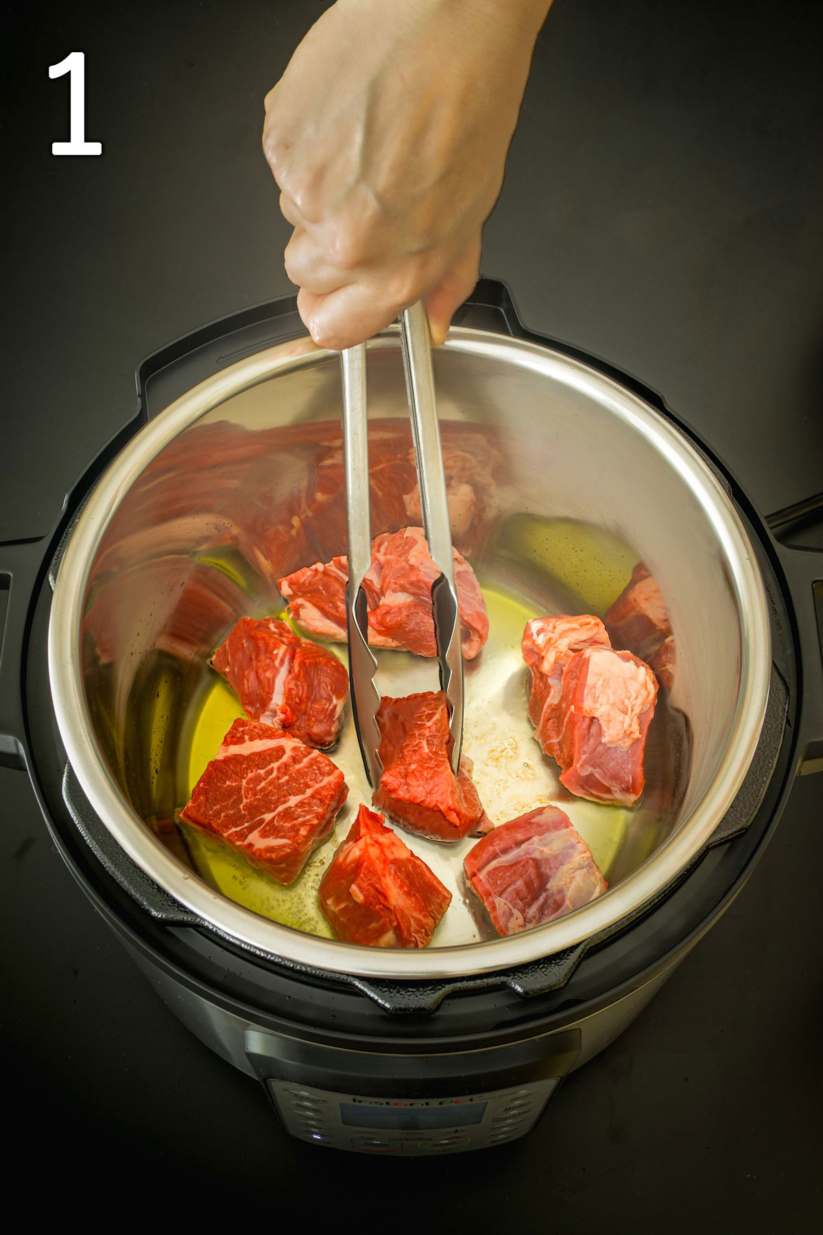 browning meat cubes in oil in the instant pot.