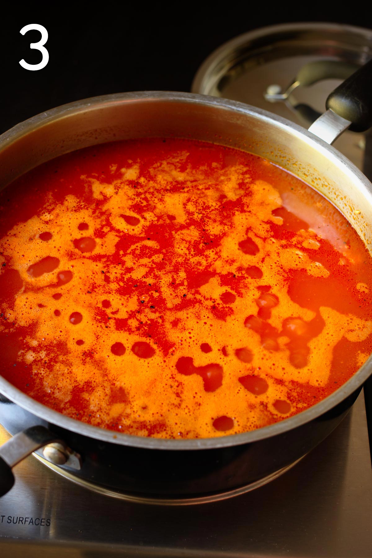 tomato broth simmering in skillet.