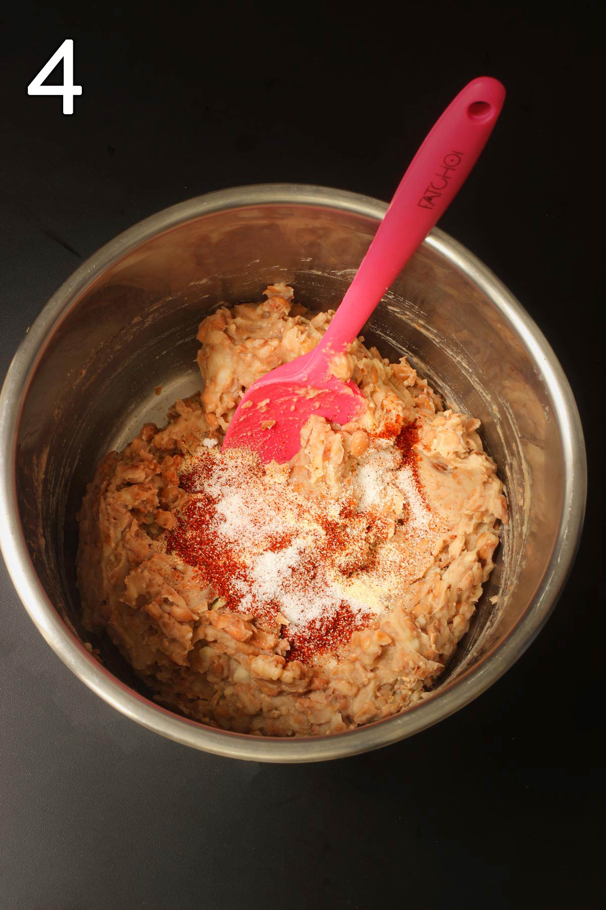 adding spices to refried beans in instant pot insert.
