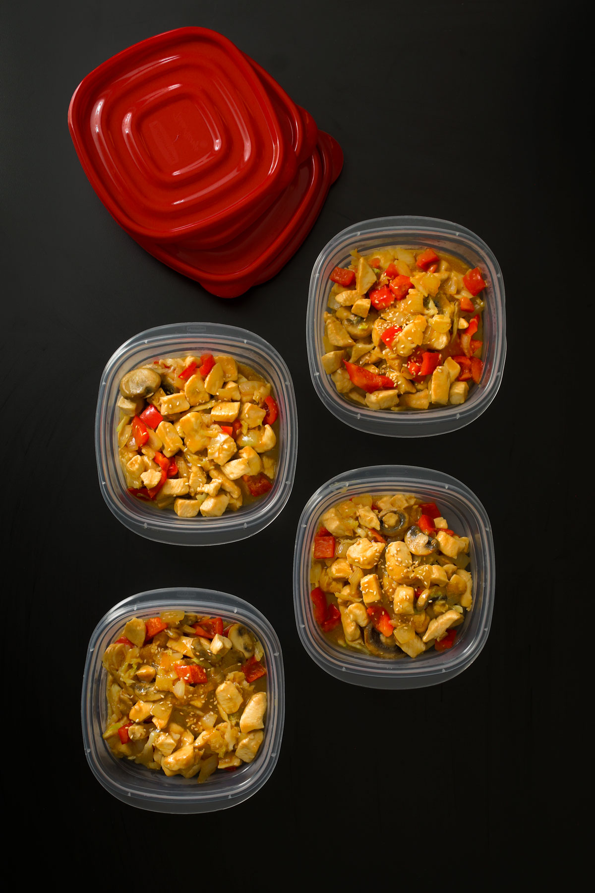 chicken and vegetable stir fry in meal prep containers ready to freeze.