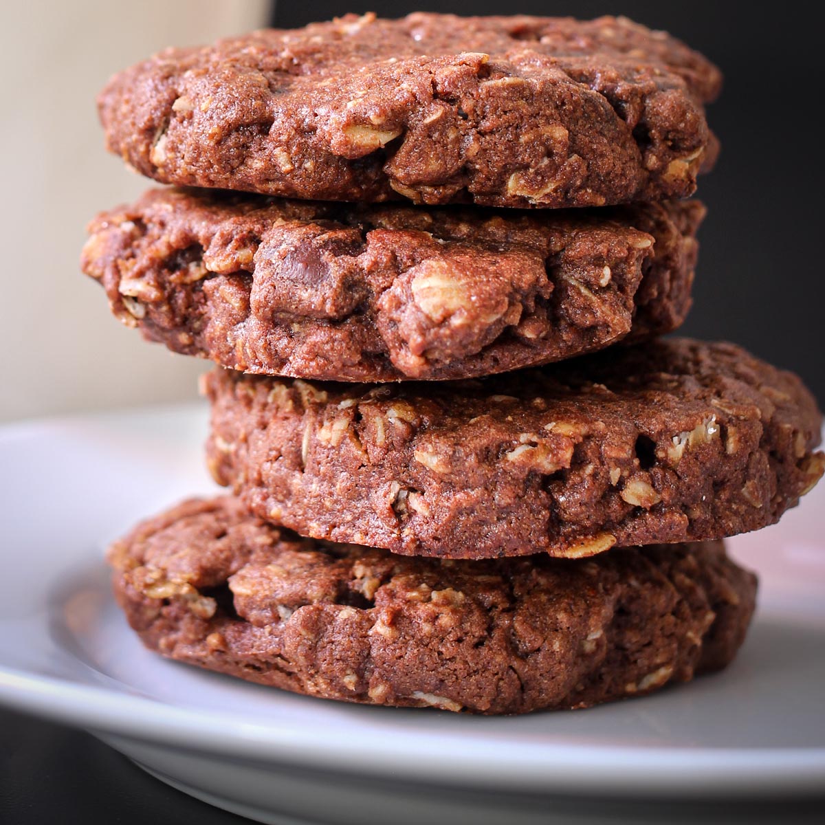stack of double chocolate oatmeal cookies on white plate.