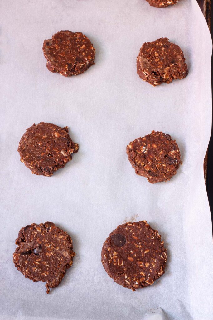 pressed cookies on parchment-lined baking sheet