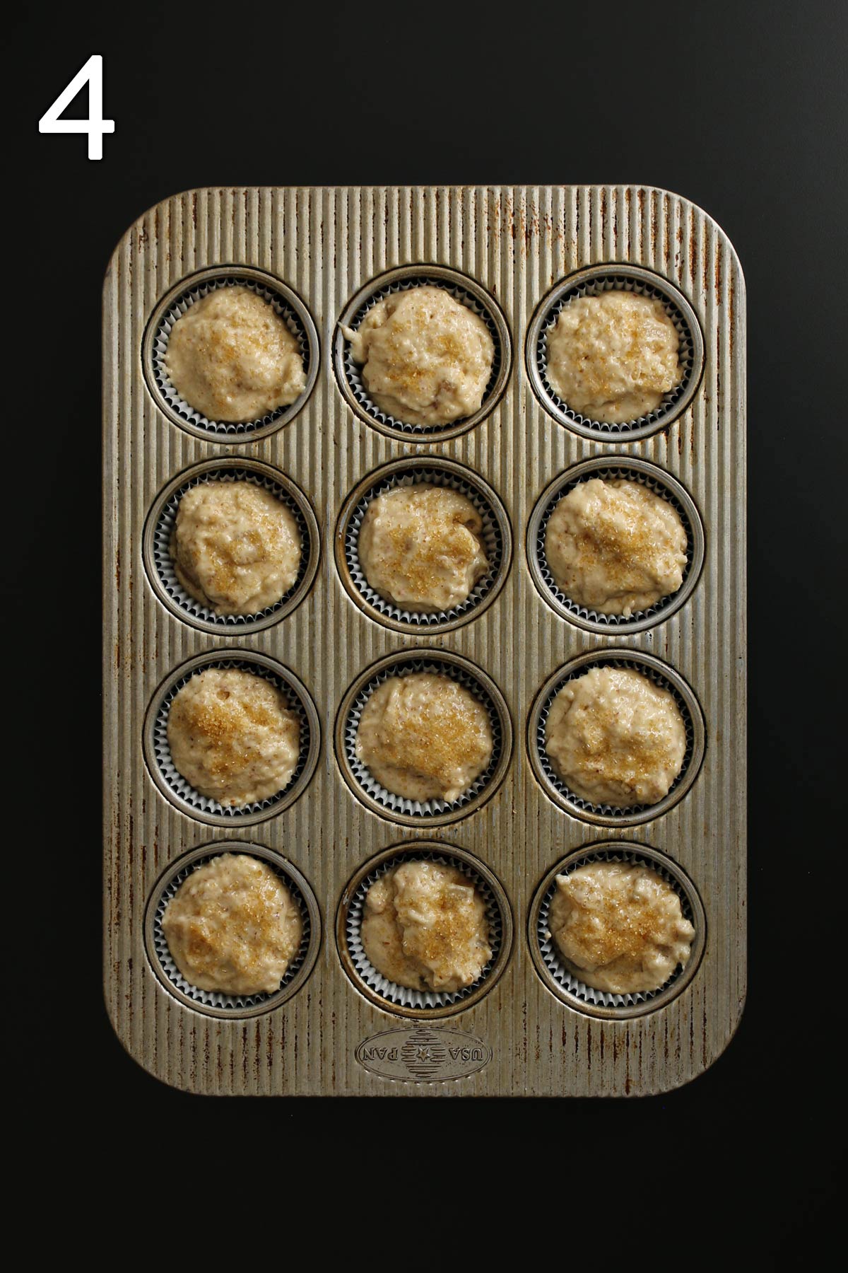 vegan muffin batter in lined muffin tin.